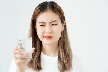 Asian woman feel sensitive teeth after drinking cold, female suffer tooth, decay problems, dental care, tooth extraction, decay problem, bad breath, Gingival Recession, Oral Hygiene instruction