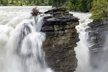 Close up view of large rock formation of hard quartzite in middle of Athabasca Falls, AB, Canada,...