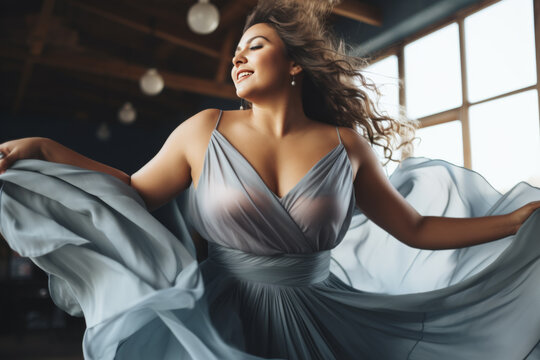 Attractive Plus-size woman wearing dress dancing, having fun moving and listening to music