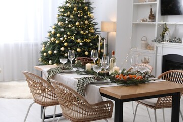 Christmas table setting with festive decor and dishware in living room