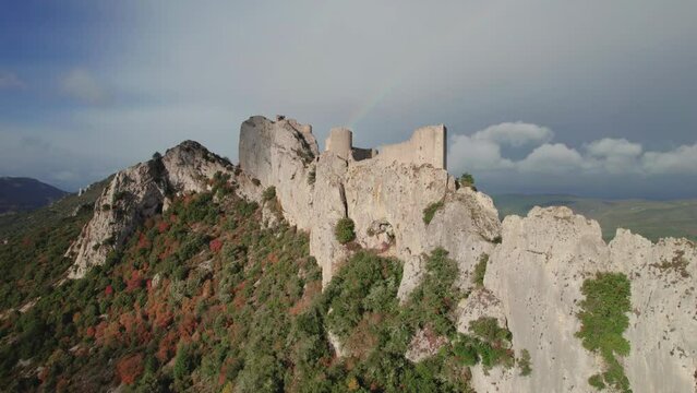 Aerial revealing shot of the Peyrepertuse castle ruins in France during autumn.