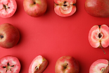 Frame made of tasty apples with red pulp on color background, flat lay. Space for text