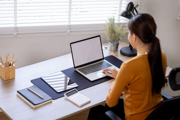 Young business asian woman work on laptop desk doing math finance on an office desk, tax, report, accounting, statistics, and analytical research concept