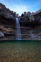 Long Exposure Vertical Shot of El Salt de La Portellada Waterfall with Smooth River Surface, Teruel, Spain