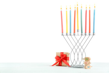 Hanukkah celebration. Menorah with colorful candles, dreidels and gift box on white background