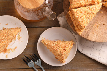 Delicious Napoleon cake served on wooden table, flat lay