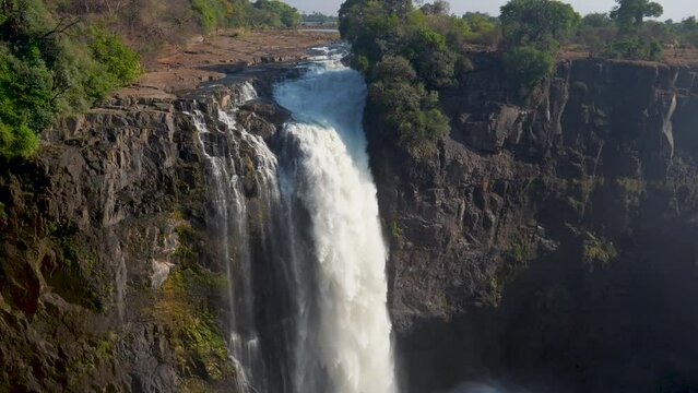 Victoria Falls in Africa. One of the leads of the waterfalls on a huge monolithic wall. Safari in Africa