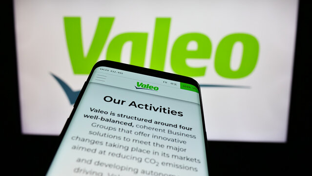 Stuttgart, Germany - 11-23-2023: Mobile phone with webpage of French automotive supply company Valeo S.A. in front of business logo. Focus on top-left of phone display.