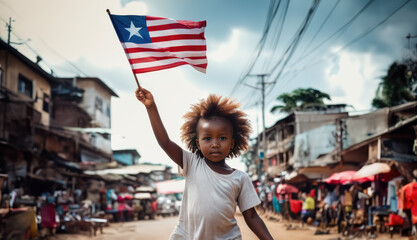 Liberian girl holding Liberia flag in Monrovia street - obrazy, fototapety, plakaty