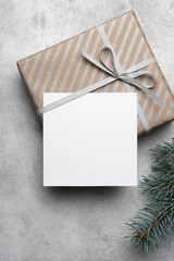 Christmas or New Year holidays card mockup with copy space, blank square card with gift box