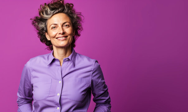 Confident Central European non-binary person in their 40s with curly hair, wearing a lilac shirt, standing against a purple background