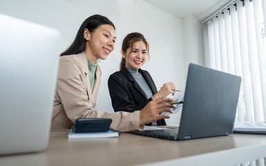 Business team two colleague are sitting at the meeting room and discuss chart and statistics
