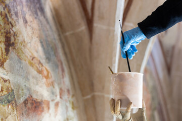 Painter Hands Restoration Work On Gothic Fresco in Historic Church. Skilled and Confident Artisan...