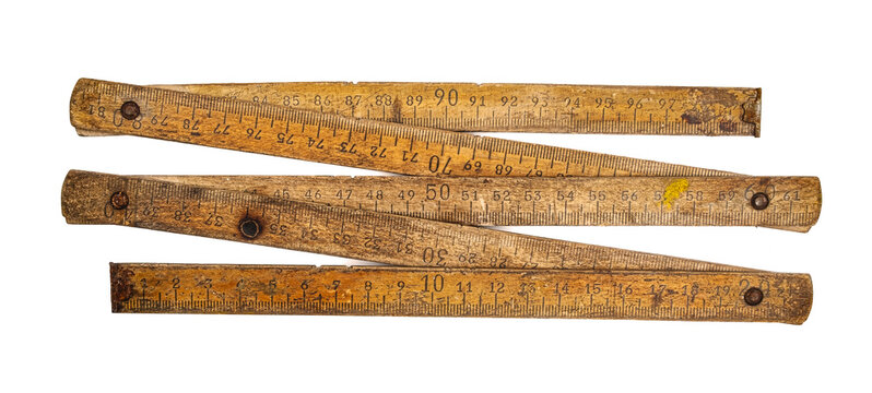 Old wooden folding meter ruler measuring centimeters on the white surface