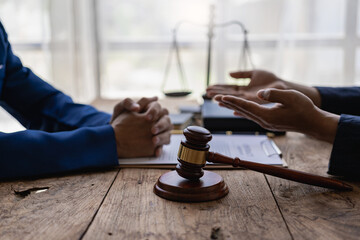 Businessman and male lawyer discuss team meeting
Judge hammer and justice scales having team meeting at law office