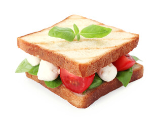 Delicious Caprese sandwich with mozzarella, tomatoes, basil and pesto sauce isolated on white