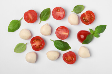 Mozzarella, tomatoes and basil on white background, flat lay. Caprese salad ingredients