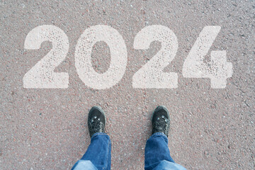 Year 2024 written on road as New Year's Eve resolution concept