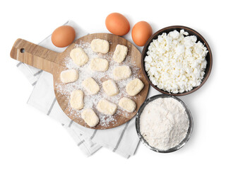 Making lazy dumplings. Wooden board with cut dough and ingredients isolated on white, top view
