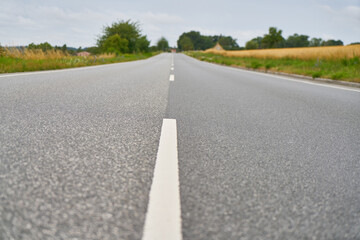 Close-up of lane markings on empty asphalt road in rural Sweden
