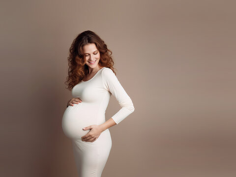 Pregnant happy woman touching her belly. Close-up portrait of a middle-aged pregnant mother caressing her belly and smiling. Healthy pregnancy concept, studio photography