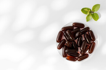 Capsules with lecithin gel on a medical plate. Soy lecithin. Vitamin and dietary supplements.