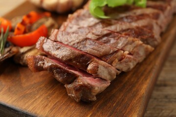Delicious grilled beef steak on table, closeup