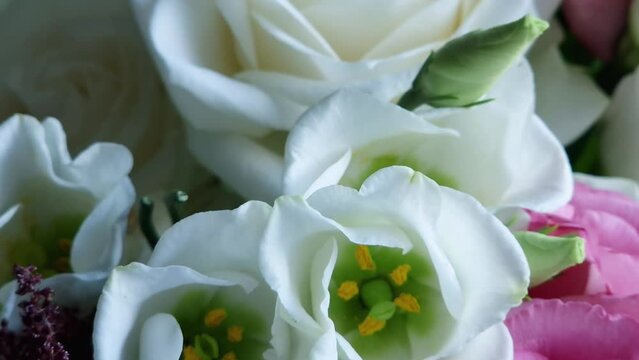 White eustoma flowers and roses in bouquet close-up