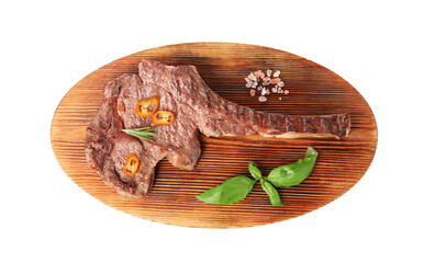 Wooden board with delicious fried beef meat, chili pepper and basil isolated on white, top view