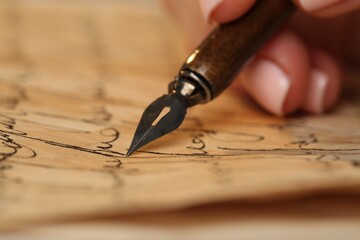 Woman writing letter with fountain pen, closeup