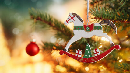 Christmas tree Toy horse wooden decoration on branch tree on background bokeh of side flickering...