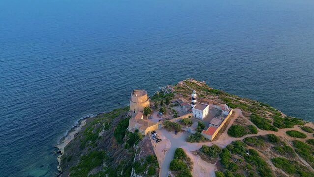 Calamosca Tower with the adjacent lighthouse dominating the small beach