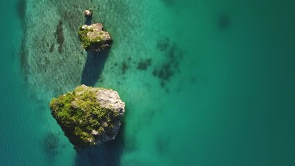 Famous floating rock on Upi Bay, Isle of Pines, aerial vertical flyover. - Powered by Adobe