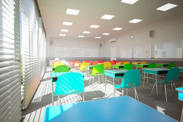 Modern Classroom with Multicolored Chairs and Sunlit Interior Design