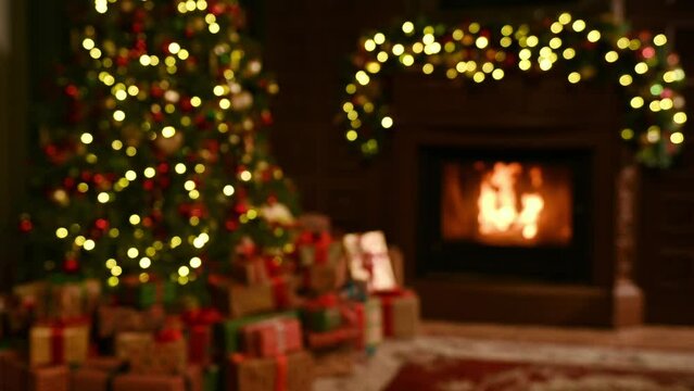 Atmospheric living room decorated for Christmas. Christmas tree with gifts and fireplace in the living room. High quality 4k footage