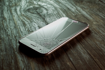 Damaged Rose Gold Smartphone with Cracked Screen on Wooden Background