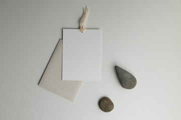 A composition with stones and a paper envelope with a postcard