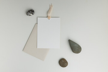 A composition with stones and an envelope with a postcard