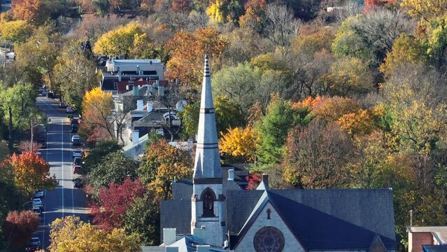 Church steeple in American town during autumn. Aerial view.
