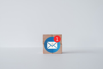 Envelope with  new notification icon on wooden cubes over white background idea for advertising,announce promotion,online marketing,notification,Reminder,Email,incoming message,Business.
