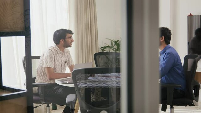 A Modern Indian Asian Male Corporate Personnel Manager taking interview of a young job applicant or seeker followed by a firm Handshake as an compliment in a startup office Workplace.