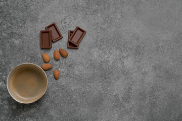 Obraz na płótnie Canvas Ceramic glass coffee style, chocolate and almond on the stone table background, grey decorative styling.