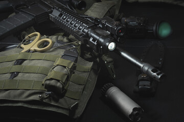 Tactical equipment, plate carrier, assault rifle with tactical flashlight, silencer and night...