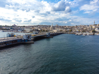 Beautiful drone view of Galata Bridge and Golden Horn Bay with passenger ferries, Istanbul, Turkey