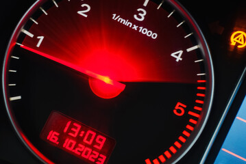 Motion blur of a car instrument panel dashboard odometer with red illuminated display.Car speedometer. High speed car speedometer and motion blur at night.