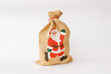 Christmas linen bag with painted Santa Claus on white background.