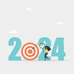 Analysis and development of business strategies for the new year 2024, planning and setting business goals. The girl looks through a magnifying glass in search of a goal for the new year.
