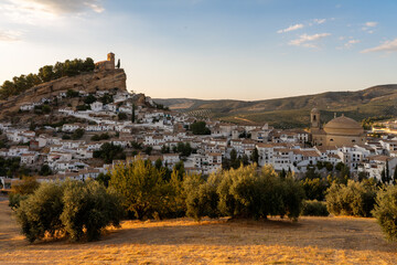 Panoramic view of Montefrio since National Geographic lookout with olive trees in the foreground at sunset. Granada, Andalucia, Spain. - obrazy, fototapety, plakaty