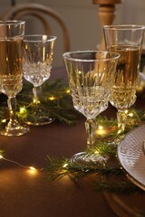 Christmas celebration. Glasses and festive decor on table