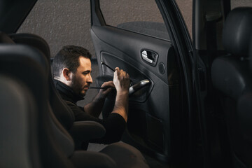 Male mechanic repairing a car door in his workshop